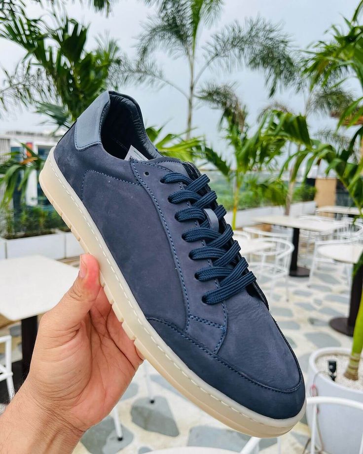 These Men's Navy Blue Sneakers offer a sleek blend of style and versatility. The premium leather upper in a rich navy hue pairs perfectly with the contrasting white sole for a modern, clean look. Designed for comfortable everyday wear, these versatile casual footwear options are perfect for everything from weekend outings to casual Fridays at the office. Experience the ideal balance of fashion and function with these essential sneakers. Navy Casual Custom Sneakers With Rubber Sole, Sporty Navy Sneakers With Stitched Sole, Navy Casual Custom Sneakers With Cushioned Footbed, Navy Leather Sneakers With Perforated Toe Box, Casual Navy Sneakers With Contrast Sole, Navy Casual Sneakers With Stitched Sole, Blue Sneakers With Contrast Sole, Navy Casual Sneakers With Plain Toe, Navy Casual Sneakers