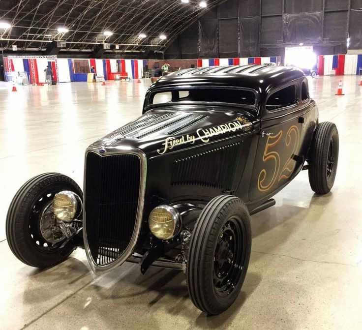 an antique car is parked in a garage