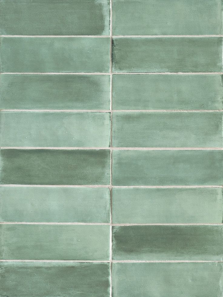 a green tile wall with horizontal lines on it