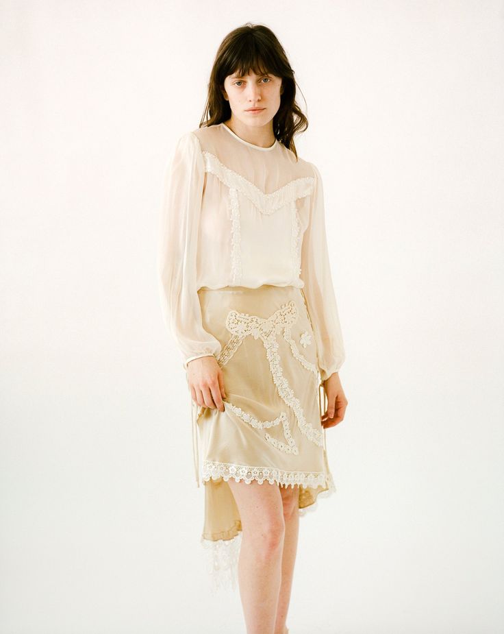 Our Viola Blouse is a play on transparency. The Viola features soft billowy sleeves and pearl buttons center back. Silk Charmeuse and Silk Chiffon. Ivory and Black Pearl buttons center back Dry Clean Only Style the Viola Blouse with our Charlie Bias Slip Skirt to complete the look. Each piece is made to order and handcrafted in our atelier. Silk Cream Evening Blouse, Cream Silk Evening Blouse, Cream Silk Blouse For Evening, Feminine Silk Chiffon Blouse For Spring, Elegant Beige Daywear Blouse, Elegant Spring Silk Chiffon Blouse, Elegant Spring Blouse With Lace Cuffs, Chic Sheer Blouse For Wedding, Sheer Long Sleeve Blouse For Wedding