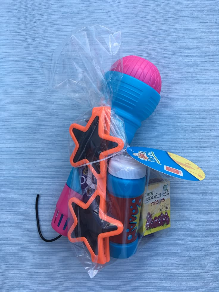 a plastic bag filled with assorted items sitting on top of a blue tablecloth