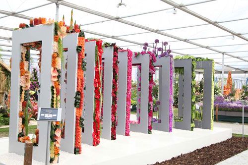 a display in a glass house with flowers on it