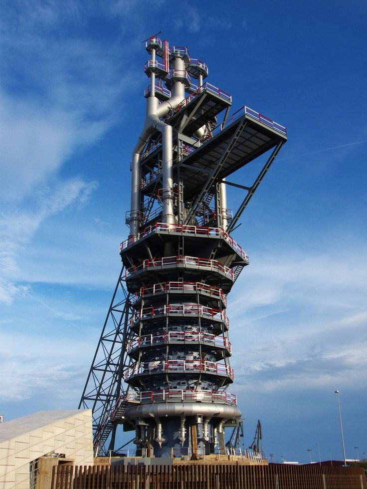 a large metal structure sitting on top of a wooden fence