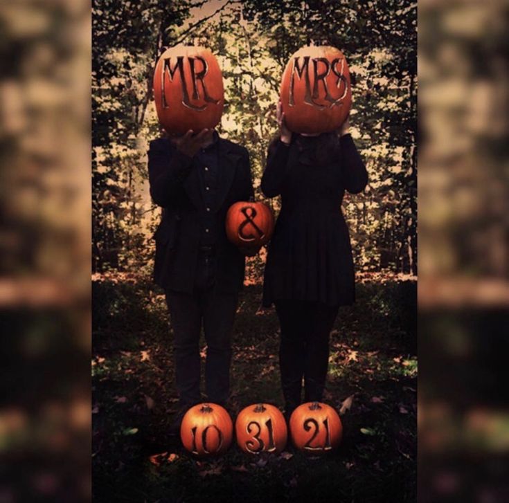 two children wearing pumpkin heads with the words mr and mrs written on them, standing next to each other