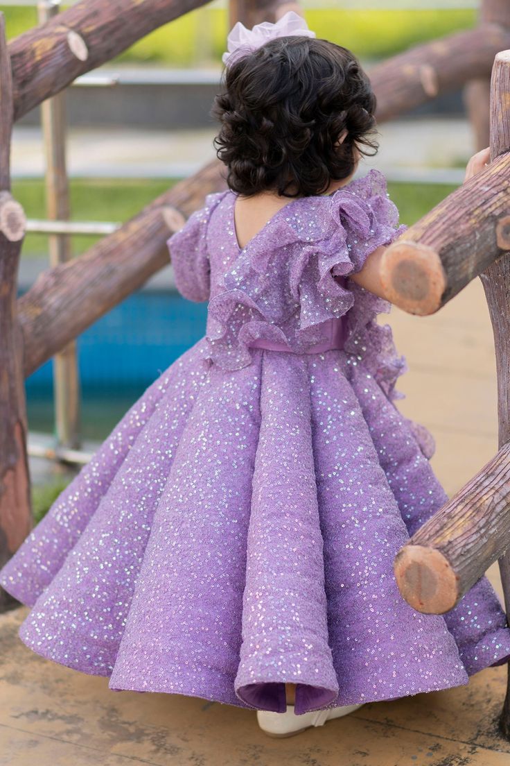 Purple flared dress with all-over sequin embellishment and butterfly motifs.
Components:1
Embellished
Neckline:V neck
Sleeve Length:Asymmetrical
Fabric:Sequin; Lining: Cotton
Color:Purple
Ruffle detail in front
Closure: Back zip
Note: Hair accessory worn by the model is not for sale - Aza Fashions Purple Embellished Pageant Dress, Purple Embellished Dress For Pageant, Purple Princess Dress With Sequins, Princess Style Purple Sequin Dress, Purple Sequined Princess Dress, Festive Purple Dress With Ruffles, Festive Purple Ruffle Dress, Festive Purple Ruffled Dresses, Purple Embellished Dress