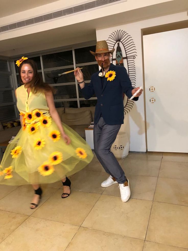 a man and woman dressed in sunflowers dancing