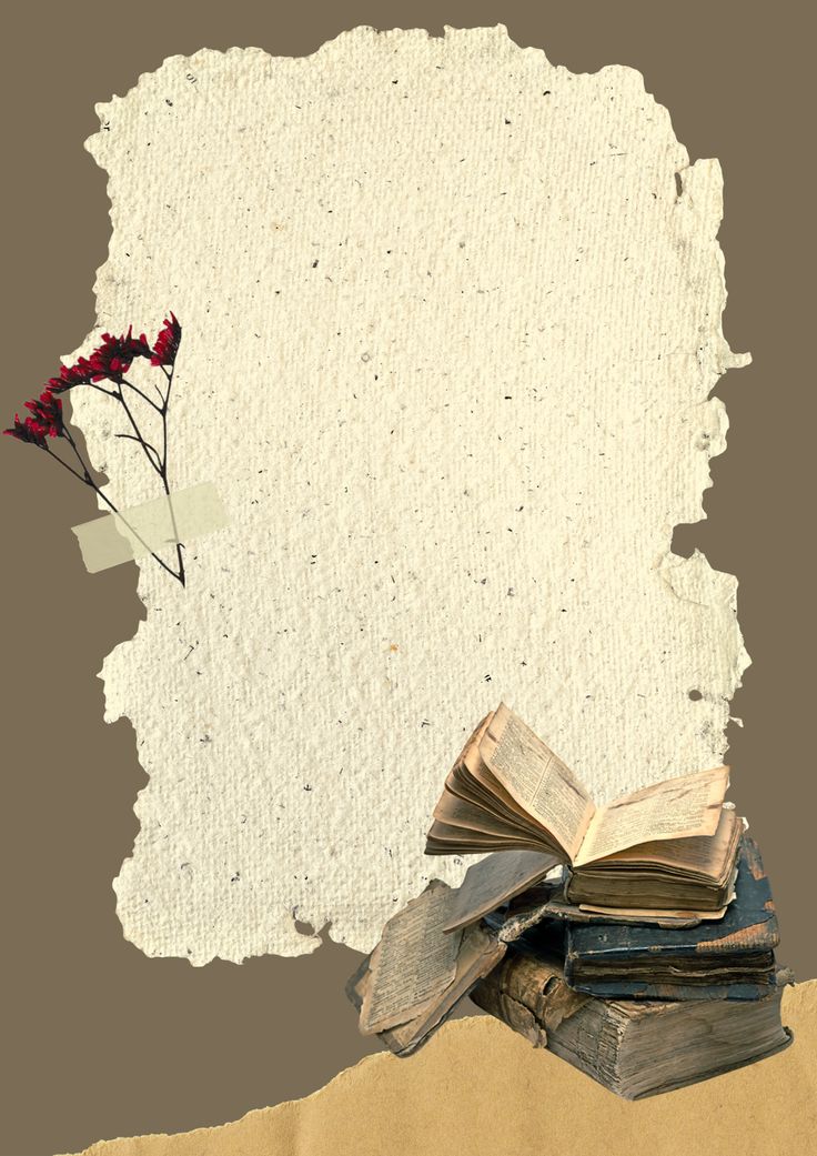 an old book and some red flowers are on top of the torn paper that has been placed in front of it