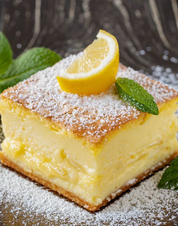 a piece of lemon cake with powdered sugar on top