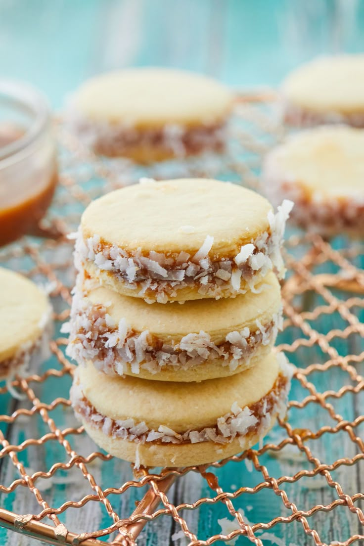 several cookies stacked on top of each other next to a jar of peanut butter and jelly