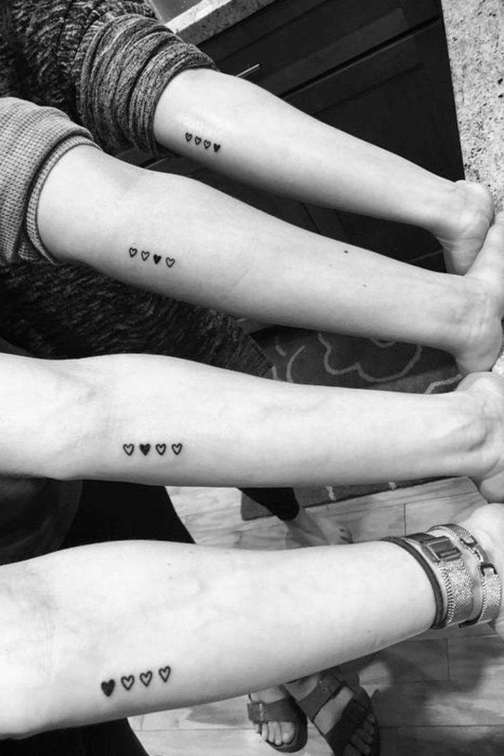 three people with matching tattoos on their arms