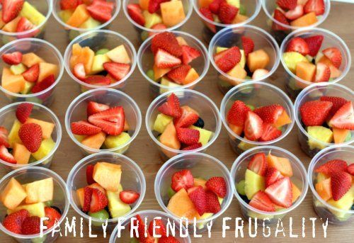 small cups filled with fruit sitting on top of a table