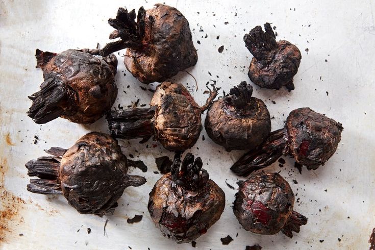 rotten mushrooms on a white surface with dirt