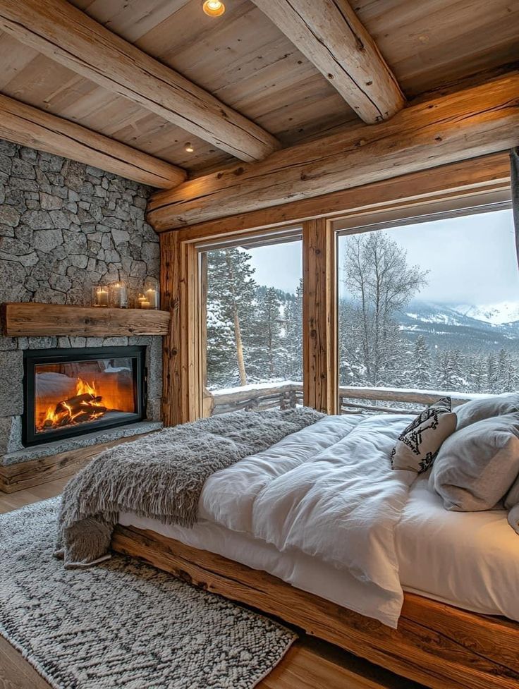 a bedroom with a stone fireplace in the corner and a large bed next to it