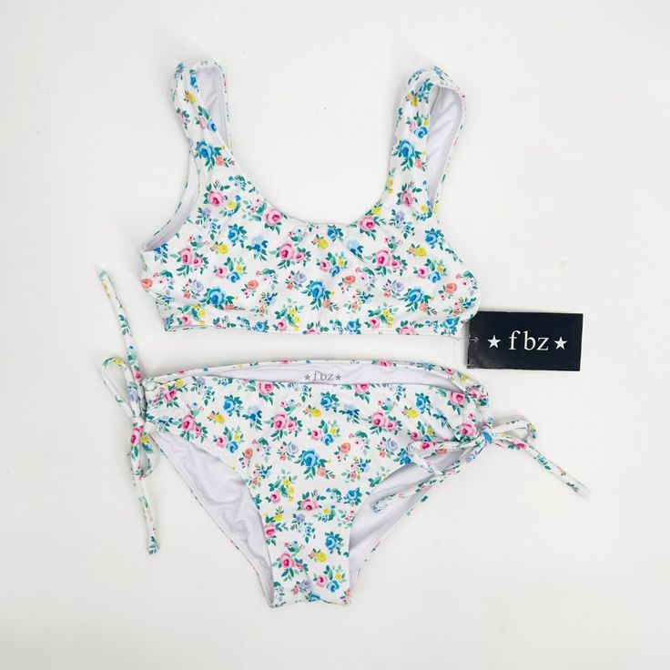 Girls White Floral Two Piece Bikini Swimsuit. Size: Xl Fabric: 80% Nylon, 20% Spandex Garment Care: Hand Wash New With Tags! Fitted Summer Playwear Tankini, Summer Stretch Tankini For Playwear, Stretch Tankini For Beach Playwear, Fitted Tankini For Playwear And Beachwear, Stretch Summer Tankini, Spring Beachwear Swimwear For Play, Beachwear Swimwear With Triangle Top For Play, Playful Fitted Tankini For Poolside, Playful Fitted Spring Tankini