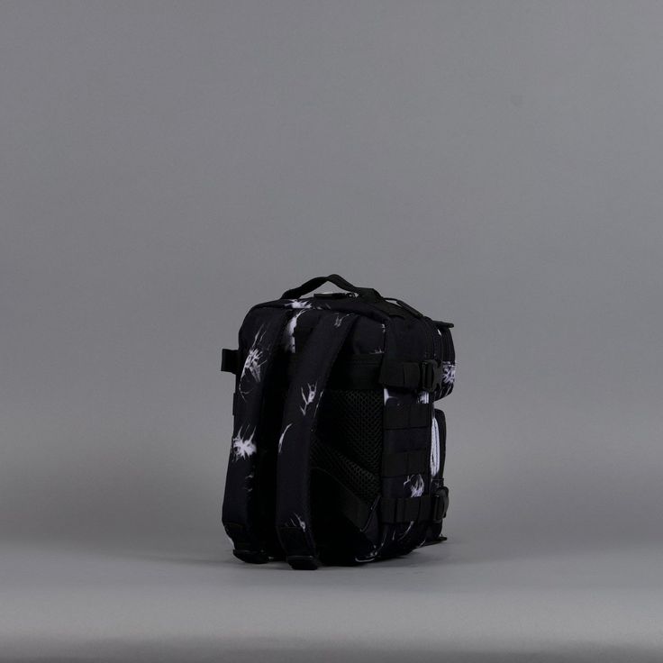 a black and white backpack on a grey background