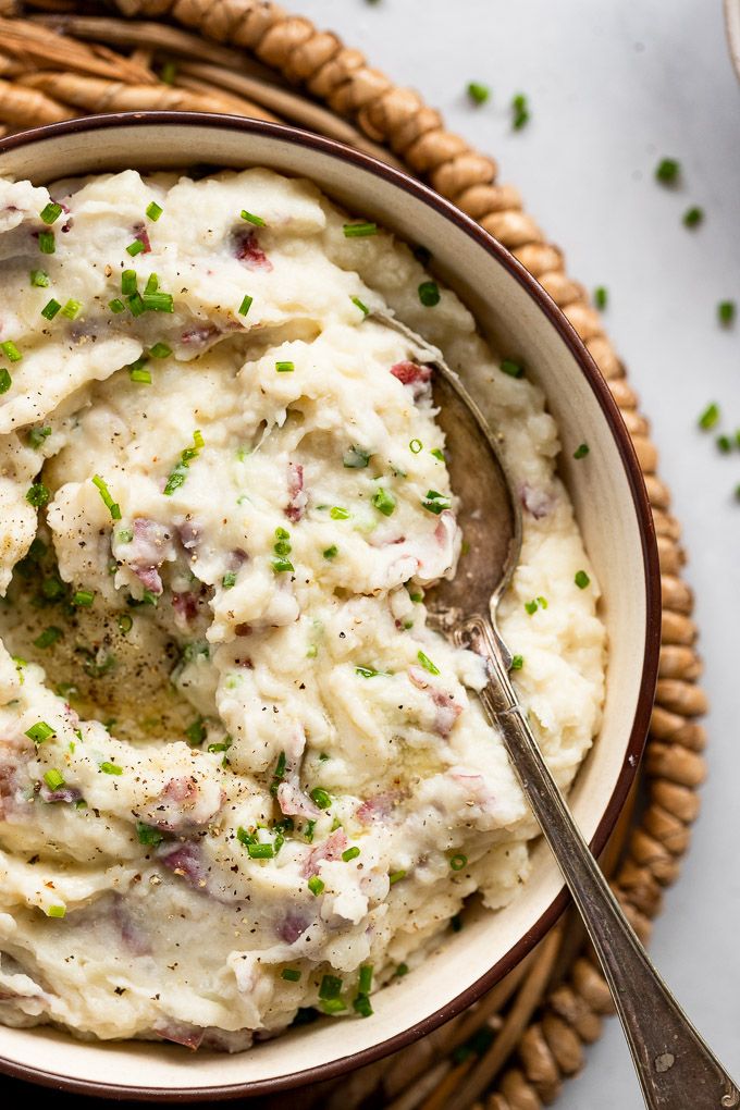 a bowl filled with mashed potatoes on top of a table