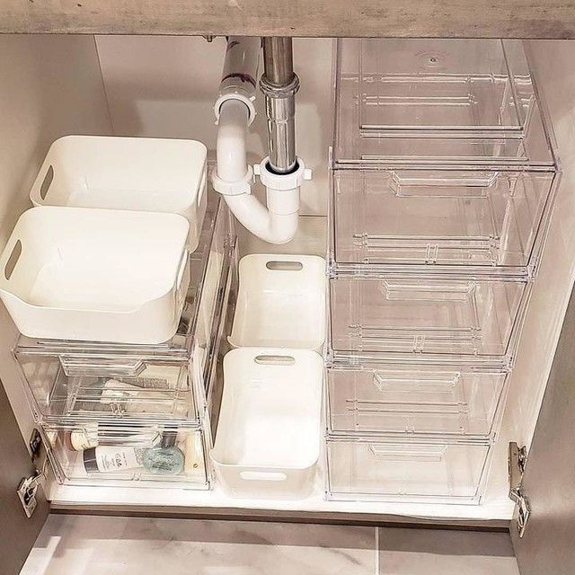 an organized pantry with plastic containers and other items in the bottom drawer, including toiletries