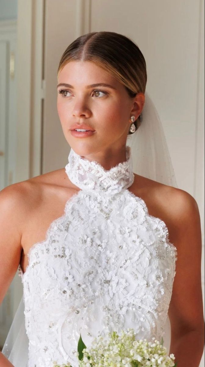 a woman in a wedding dress holding a bouquet