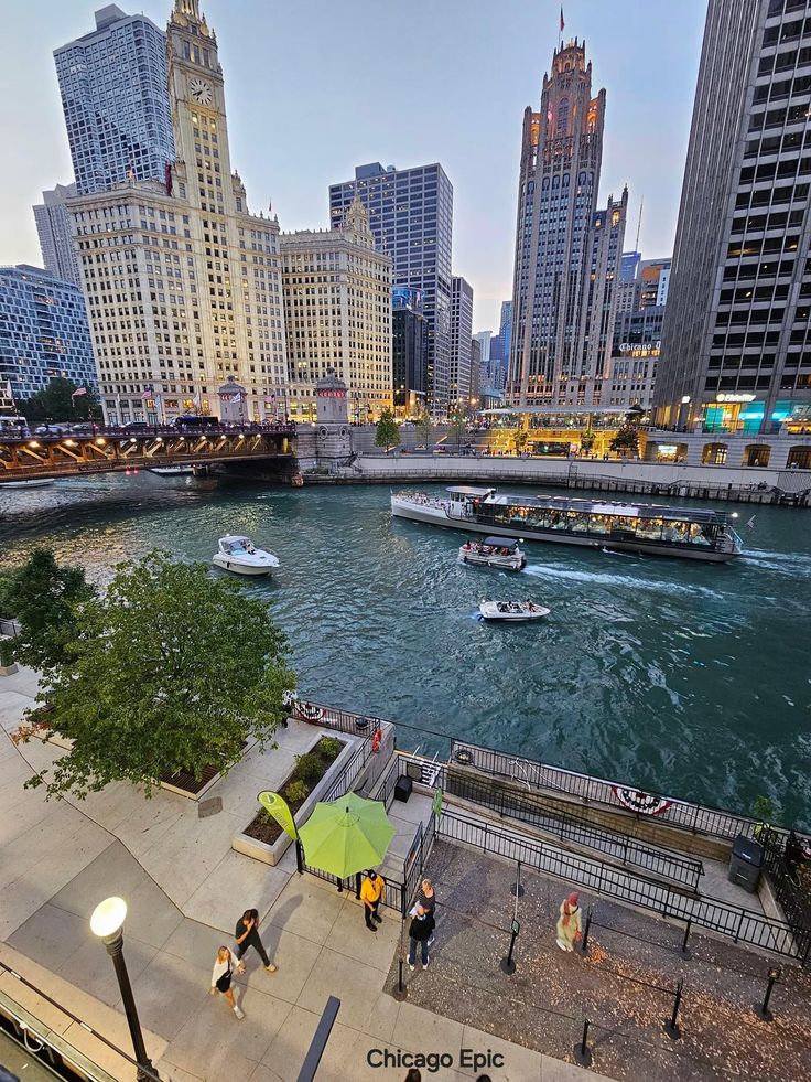 people are walking along the river in chicago