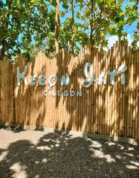 a bamboo fence with the words kiboi gate written on it in white letters