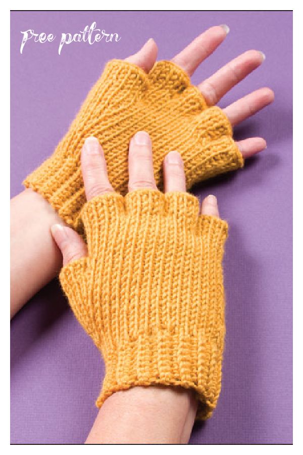 a woman's hand wearing an orange knitted glove on top of a purple surface