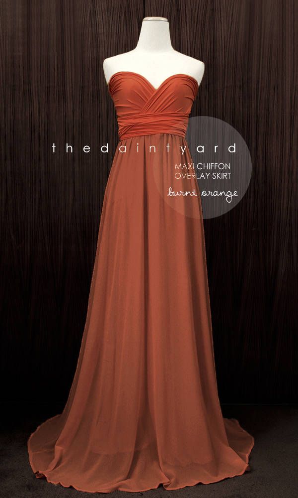 an orange dress is on display in front of a wooden background with the words, the daily