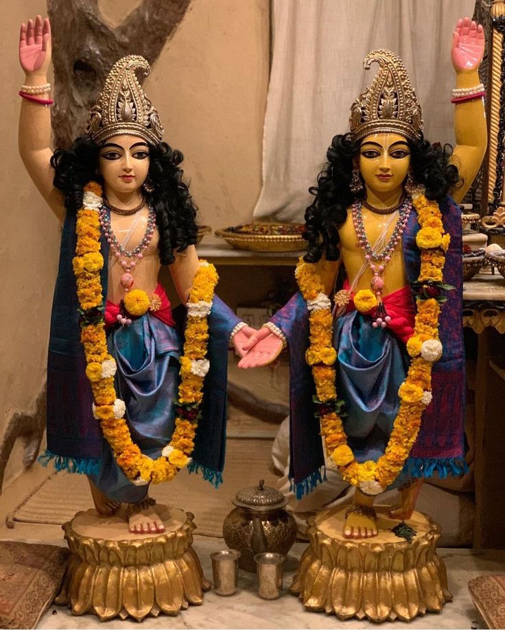 two statues of hindu deities are standing next to each other