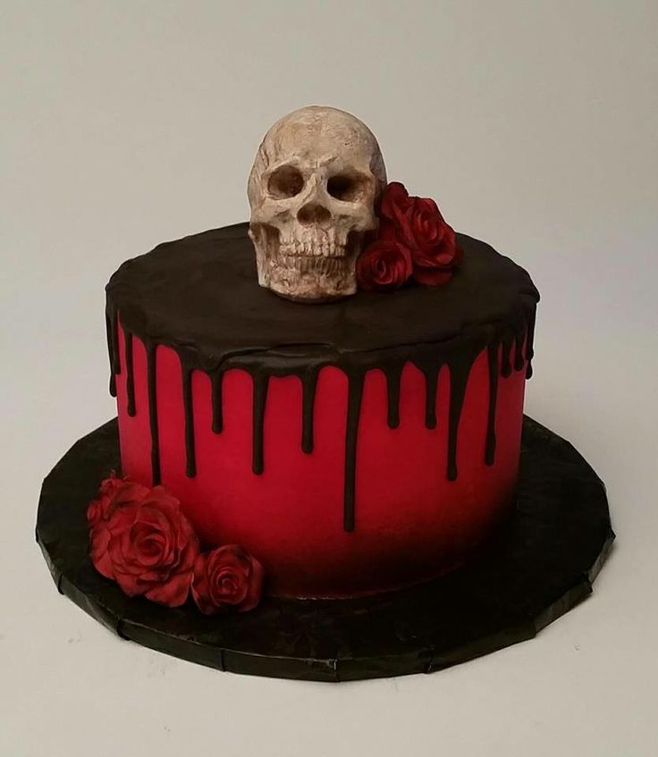 a red and black cake with a skull on top