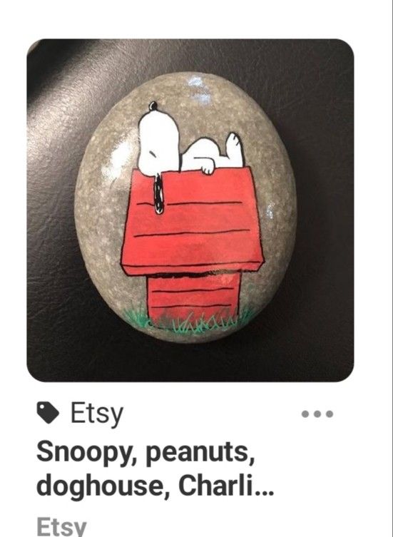 a rock with snoopy peanuts on it and the caption says, etsy snoopy peanuts, doghouse, charlie