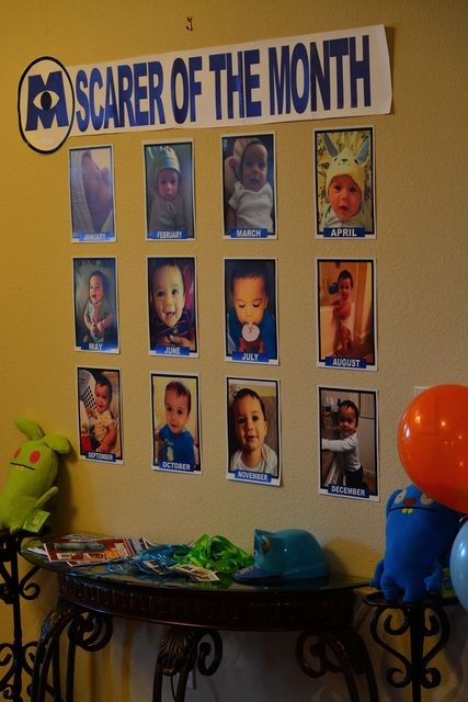 a table with balloons and pictures on it in front of a sign that says, scarer of the month