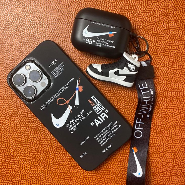 an iphone case with a lanyard attached to it next to a pair of sneakers