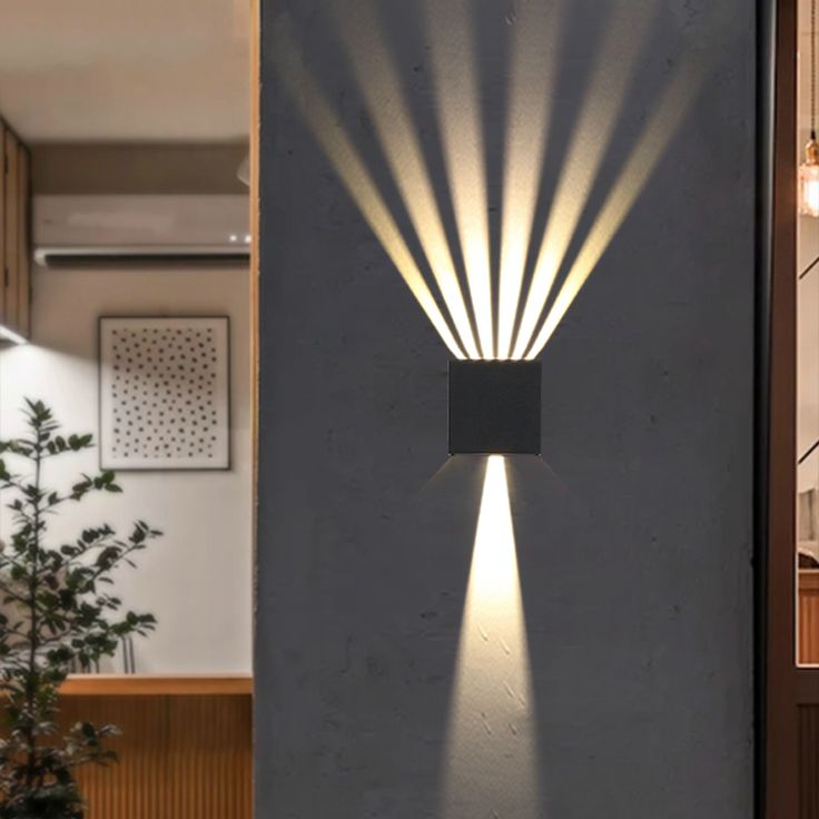 a modern outdoor wall light that is designed to look like it's coming out of the ground