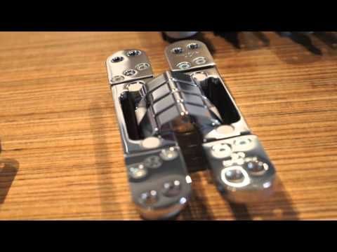 two video game controllers sitting on top of a wooden table