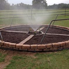 a circular fire pit in the middle of a field