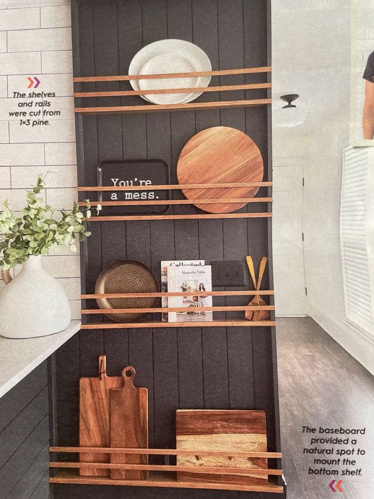 a magazine cover with plates and wooden utensils on the shelf next to it