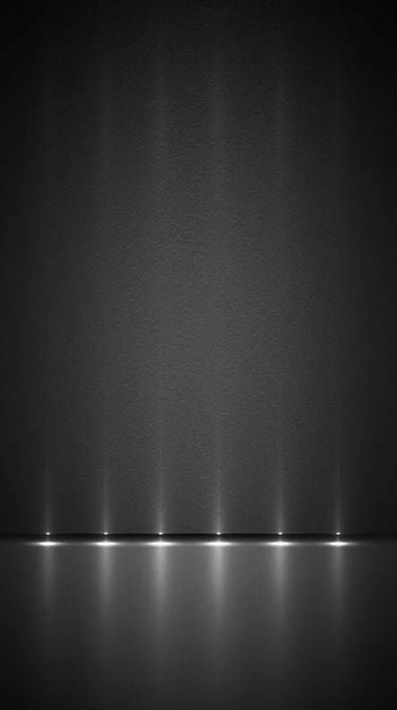 black and white photo with light coming from the top to the bottom, in an empty room