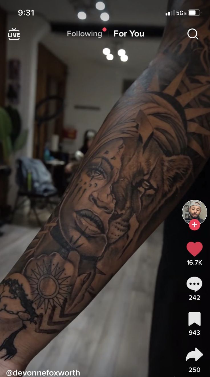 a man's arm with tattoos on it and an image of a woman in the background