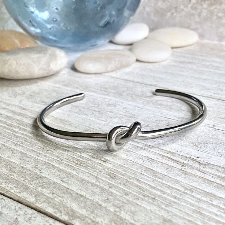 ✦ Stainless Steel✦ Size: 2.25"inner diameter ✦ Inner Circumference is 6.5" but these are super adjustable and can fit larger or smaller wrists by simply squeezing them together or pulling the two sides apart. Super sweet silver love knot bangle bracelet. Love knots represent LOVE, unity, and friendship. Would make perfect bridesmaid bracelets or gifts for someone you love. These will arrive ready for gifting in a cute boho gift box and they usually ship same day or next. KEY FEATURES*-Made of 10 Handmade Silver Bracelet For Best Friend, Dainty Handmade Cuff Bracelet For Gift, Dainty Handmade Cuff Bracelet As Gift, Handmade Dainty Cuff Bracelet For Gift, Handmade Dainty Cuff Bracelet As Gift, Silver Cuff Bracelet Bangle For Bridesmaids, Adjustable Silver Bangle For Bridesmaid Gift, Silver Cuff Bracelet For Bridesmaid Gift, Silver Cuff Bangle For Bridesmaid Gift