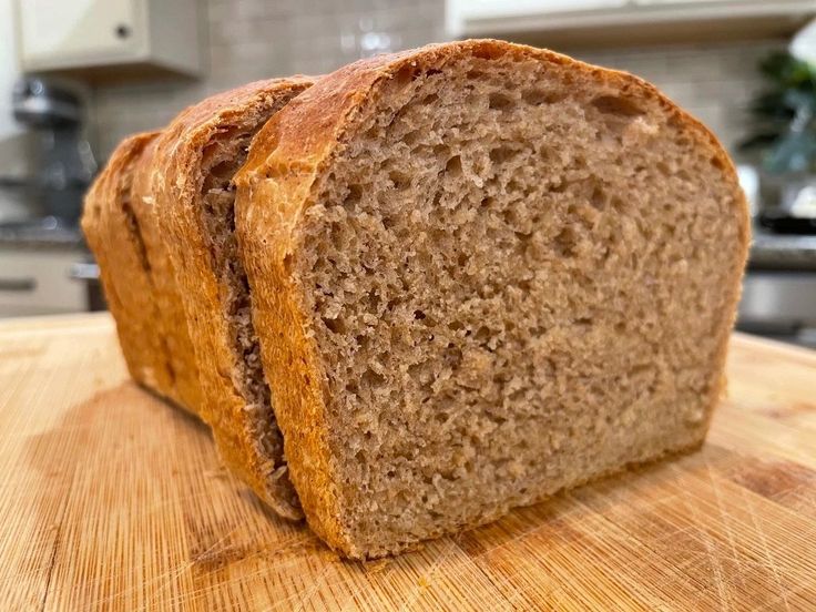 a loaf of bread sitting on top of a wooden cutting board