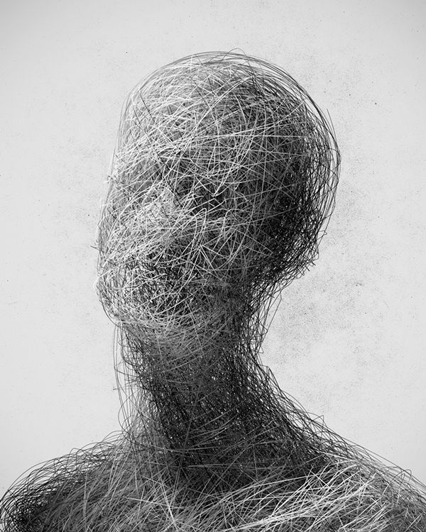 a black and white photo of a person's head made out of tangled wire