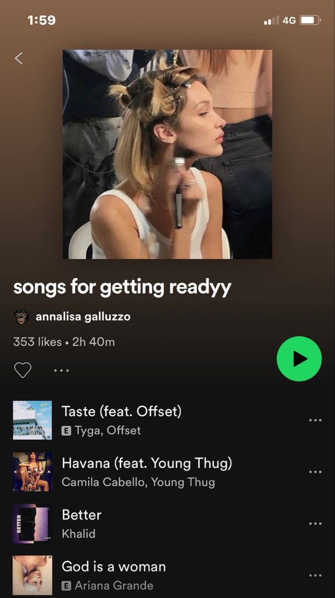 the music player is playing an album on her iphone screen, and it's also showing songs for getting ready