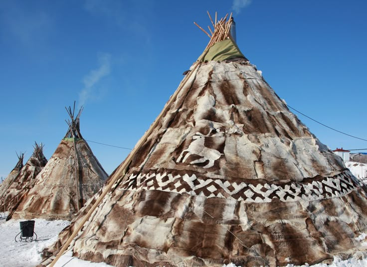 native american teepees are standing in the snow with their designs painted on them