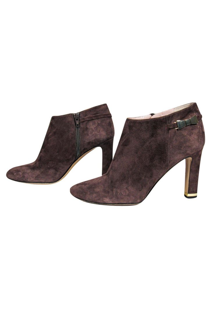 Now these are a Autumnal staple that you have to have! Made with soft suede, these heeled booties are the perfect addition to any sweater weather ensemble! Slip on your favorite chunky cardigan and high-waisted jeans for a comfortable and timeless combo. Size 10 Suede upper Rounded toe Side zipper closure Leather footbed with minimal wear Gold-toned bow and heel accent Leather sole with wear Heel 4" High Heel Booties With Stacked Heel For Winter, Winter High Heel Booties With Stacked Heel, Winter Booties With Stacked High Heel, Elegant Brown Winter Booties, Chic Ankle Boot Booties For Winter, Chic Winter Ankle Booties, Suede Lined Ankle Boot Heels For Fall, Brown Ankle-high Winter Heels, Elegant Suede Booties For Fall