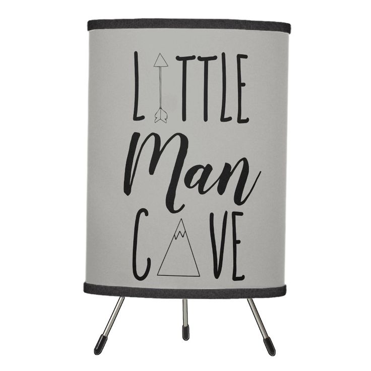 a white and black lamp with the words little man cave on it