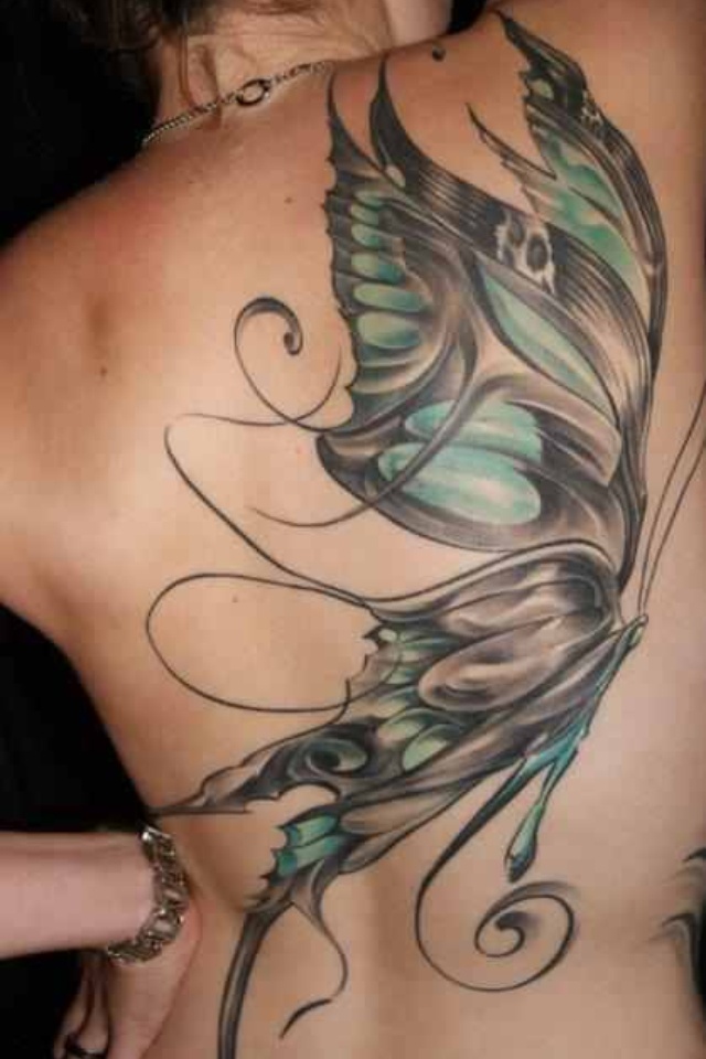 the back of a woman's body with tattoos on her stomach and butterfly wings