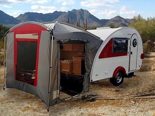 an rv is parked in the desert with its awning open and it's door opened