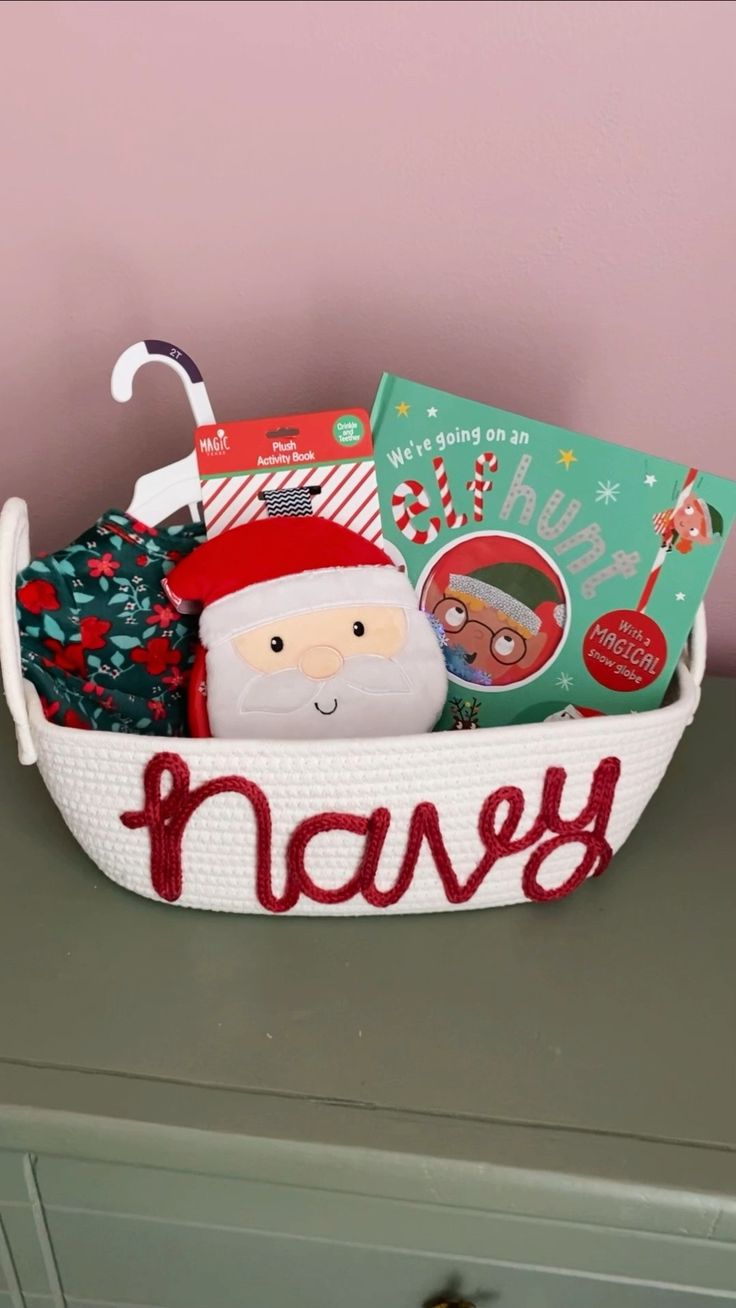 a basket filled with books and toys on top of a dresser