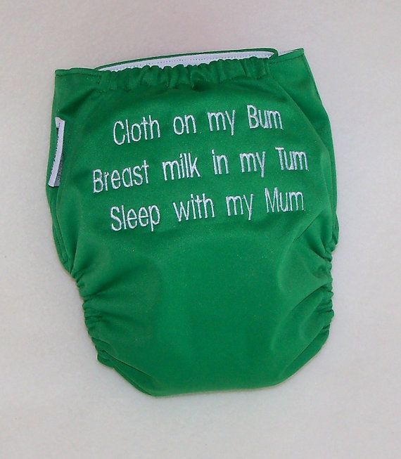 a green cloth diaper with words written on the front and bottom that says,'cloth on my bum breast milk in my tu corporate sleep with my mum '