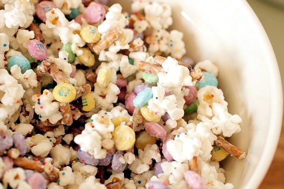 a white bowl filled with lots of candy popcorn