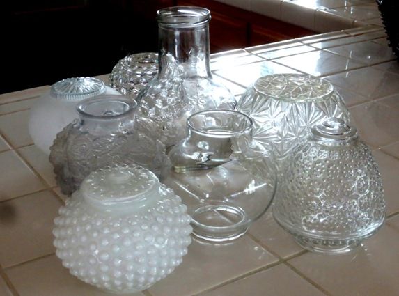 there are many glass vases on the floor